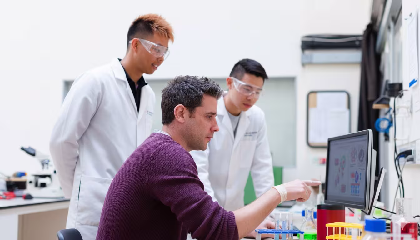 Students reviewing their vibe coded robot.